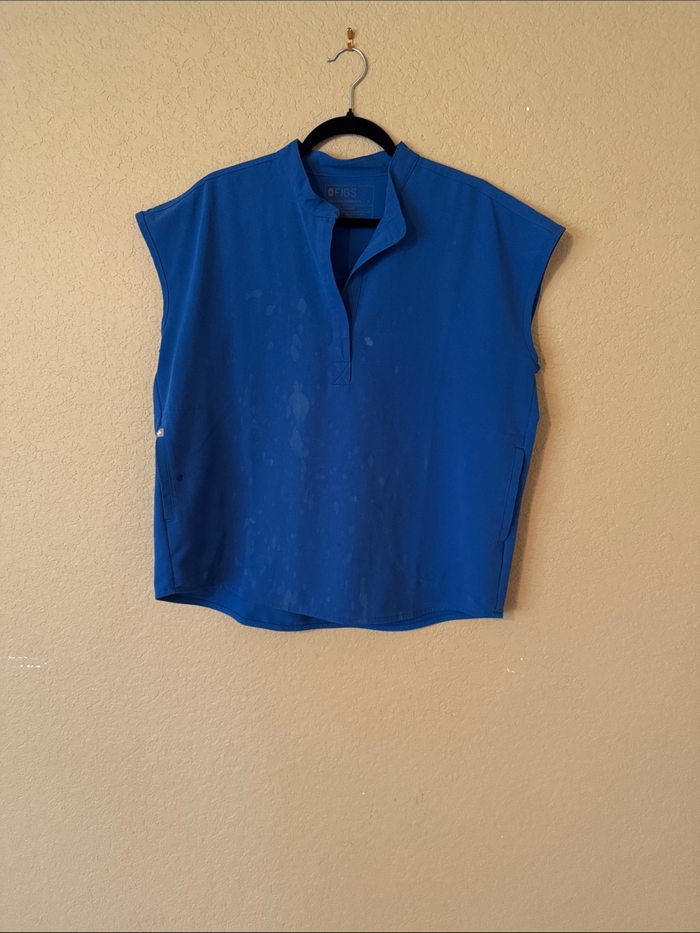 Figs Rafaela SCRUB top. Bleach stains present and an ink stain on pocket.